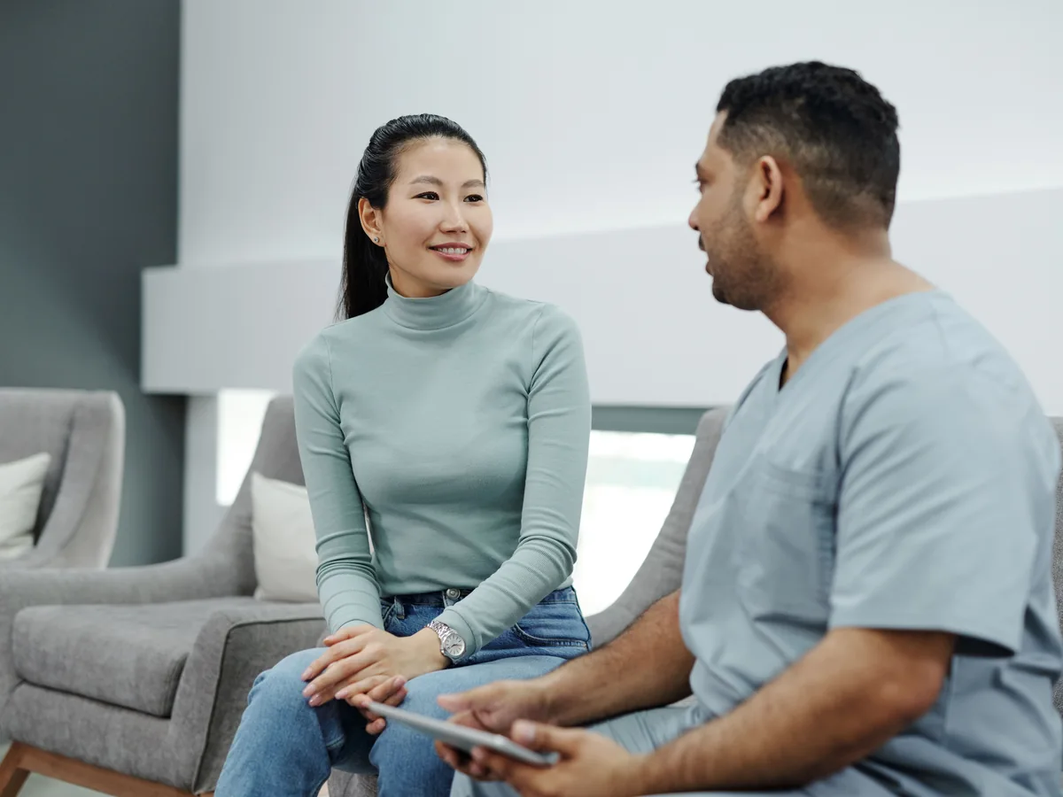 Real photo of a clinician talking with a patient during an appointment