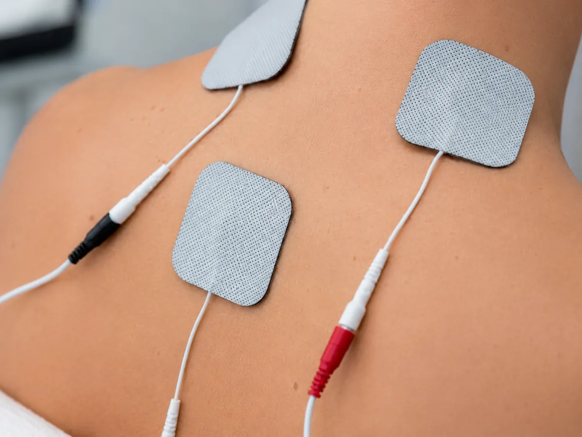 Patient receiving electrical stimulation therapy with electrode pads