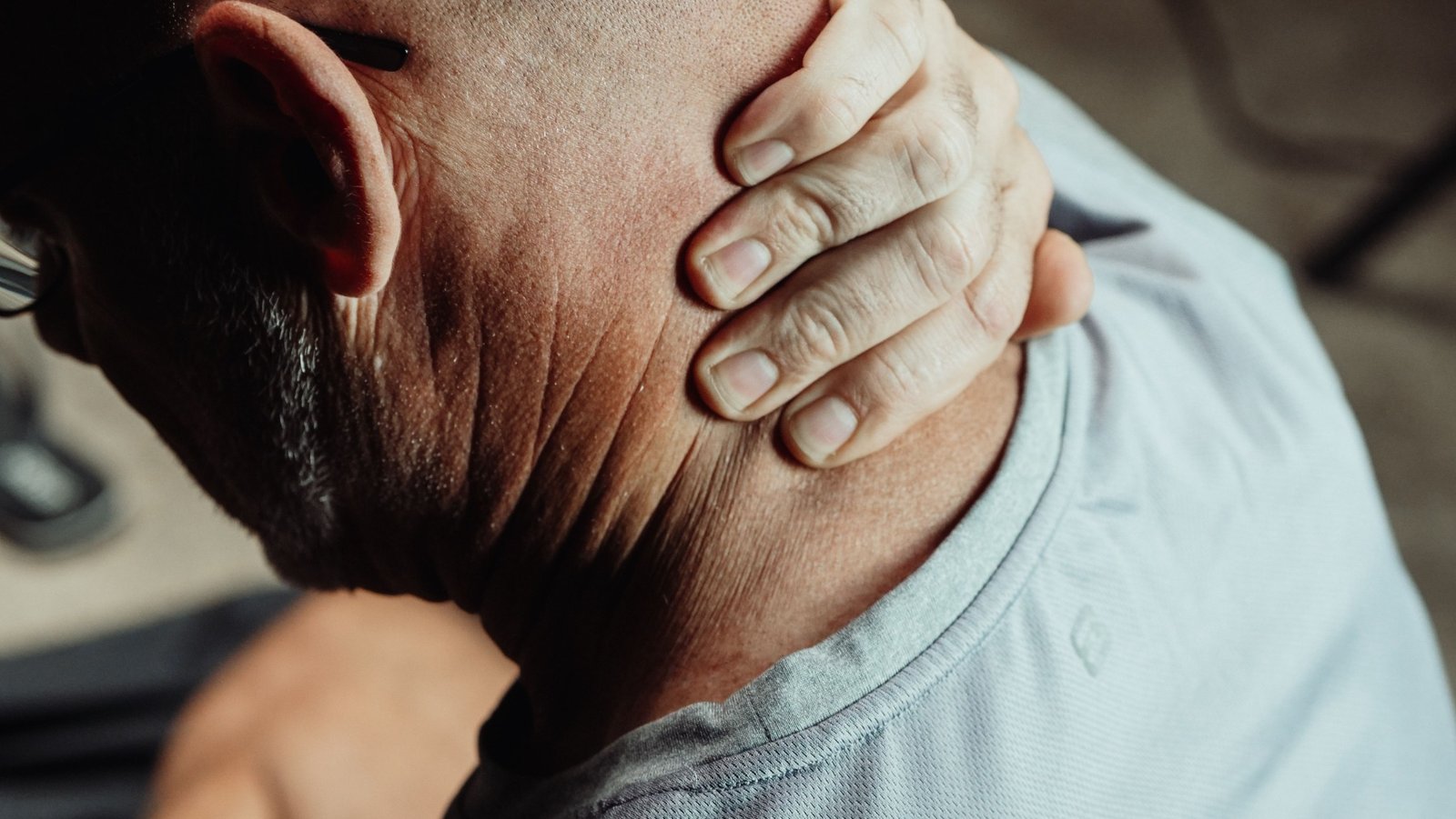 Driver experiencing neck pain after a collision